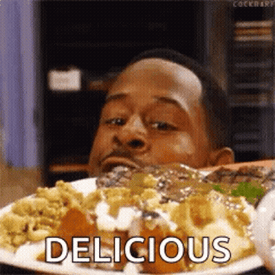 Man Sitting At Table Eating Food GIF