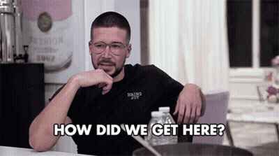 Man Sitting At Table Hand On Chin Saying How Did We Get Here GIF