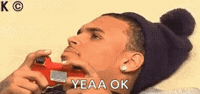Man Sitting At Table Hand On Chin Saying Yeah Okay GIF