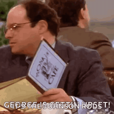 Man Sitting At Table Holding Menu GIF