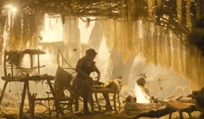 Man Sitting At Table In Cave With Fire GIF
