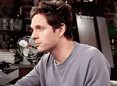 Man Sitting At Table In Front Of Fan GIF