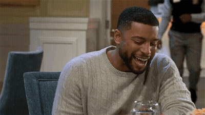 Man Sitting At Table Laughing With Water And Food GIF