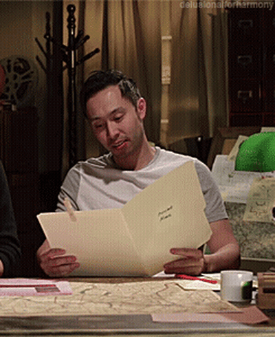 Man Sitting At Table Reading Harmony GIF