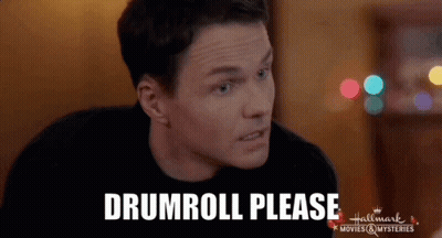 Man Sitting At Table Saying Drumroll Please GIF
