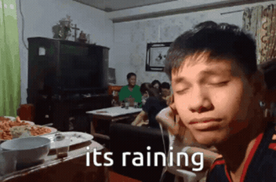 Man Sitting At Table Saying It's Raining GIF