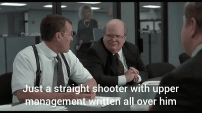 Man Sitting At Table Saying Just A Straight Shooter With Upper Management Written All Over Him GIF