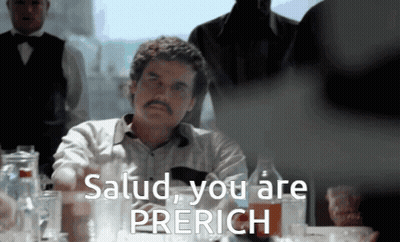 Man Sitting At Table Saying Salud You Are Prerich GIF