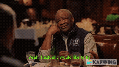 Man Sitting At Table Saying Yeah I Actually Would Like To Try GIF