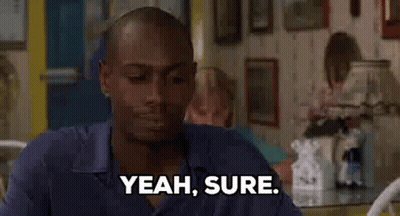Man Sitting At Table Saying Yeah Sure GIF