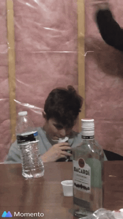 Man Sitting At Table With Bacardi Bottle GIF