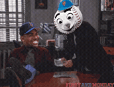 Man Sitting At Table With Baseball Mask GIF