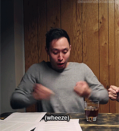 Man Sitting At Table With Beer And Sign Wheeze GIF