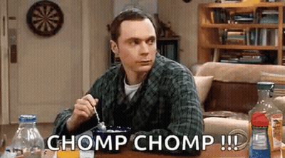 Man Sitting At Table With Bowl Of Cereal And Spoon In Mouth GIF