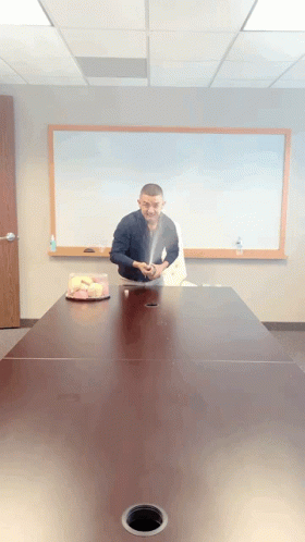 Man Sitting At Table With Cake GIF