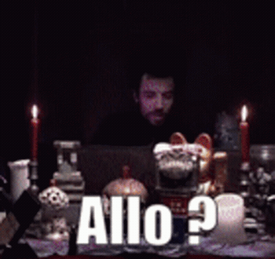 Man Sitting At Table With Candles And Allo Sign GIF