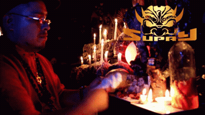 Man Sitting At Table With Candles And Supply Logo GIF