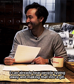 Man Sitting At Table With Coffee Mug And Paper GIF