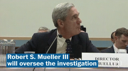 Man Sitting At Table With Director Sign GIF