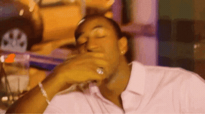 Man Sitting At Table With Eyes Closed And Hand On Mouth GIF