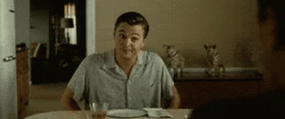 Man Sitting At Table With Food And Alcohol GIF