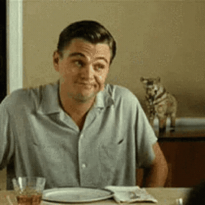 Man Sitting At Table With Food And Cat GIF
