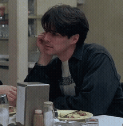 Man Sitting At Table With Food And Cigarette GIF