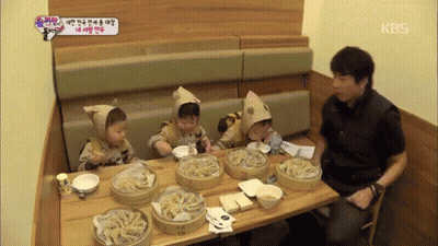 Man Sitting At Table With Food And KBS Sign GIF