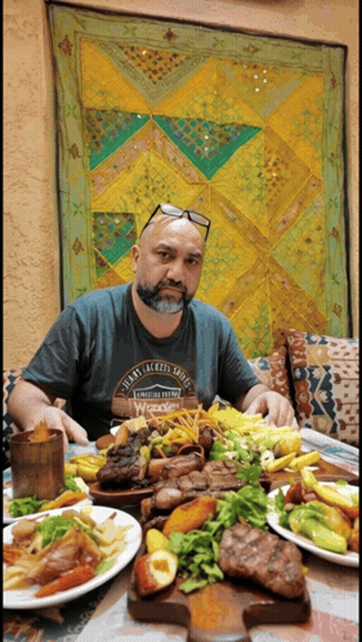 Man Sitting At Table With Food And Twenty Jackson Shoes Shirt GIF
