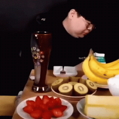 Man Sitting At Table With Fruit And Beer GIF