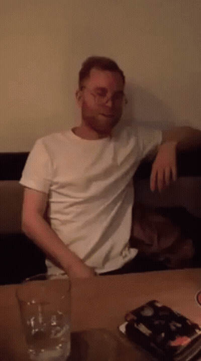 Man Sitting At Table With Glass Of Water GIF