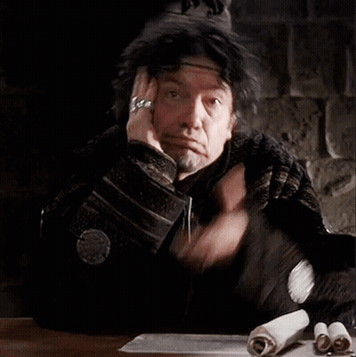 Man Sitting At Table With Hand On Head GIF