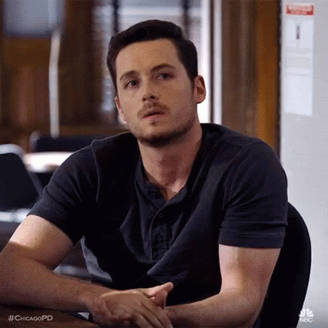 Man Sitting At Table With Hands Folded GIF