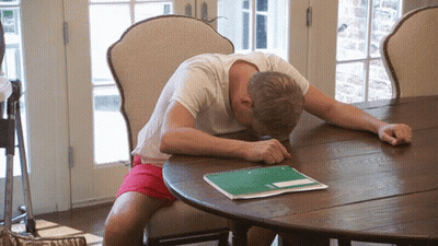 Man Sitting At Table With Head On Notebook GIF
