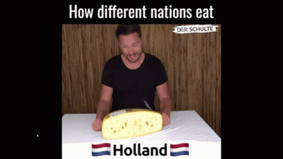 Man Sitting At Table With Holland Cheese GIF