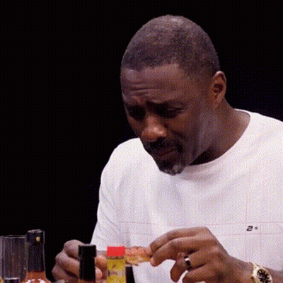 Man Sitting At Table With Hot Sauce And Pizza GIF