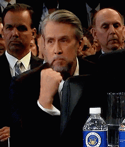 Man Sitting At Table With Lamp And Flowers GIF
