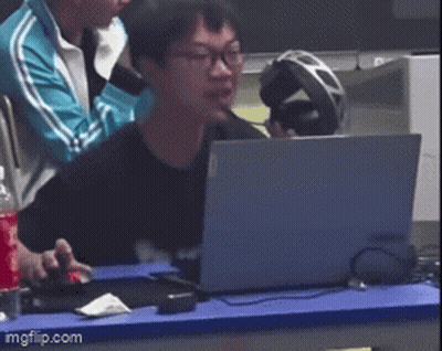 Man Sitting At Table With Laptop And Headphones GIF