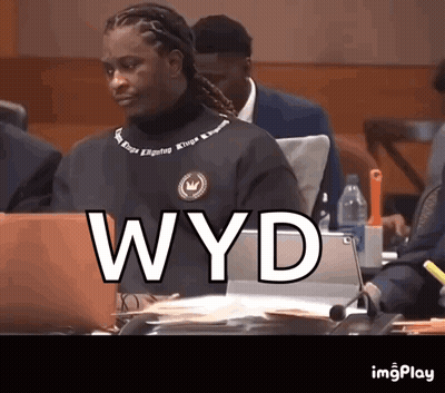 Man Sitting At Table With Laptop Saying WYD GIF