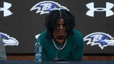 Man Sitting At Table With Microphone And Water GIF