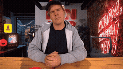 Man Sitting At Table With N Sign GIF