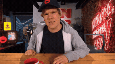 Man Sitting At Table With N Sign GIF