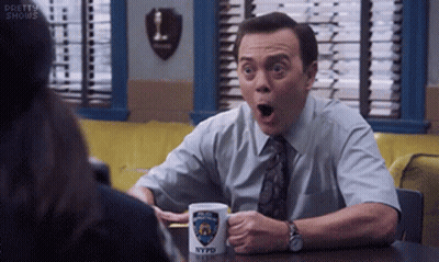 Man Sitting At Table With NYPD Mug GIF
