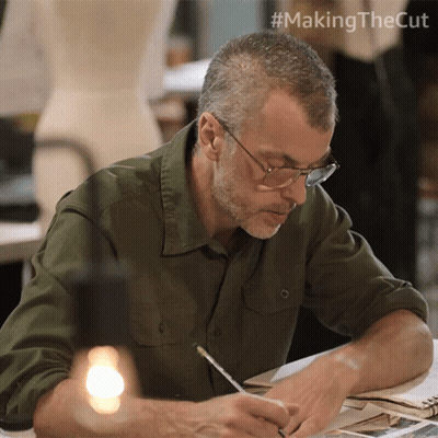 Man Sitting At Table With Pencil GIF