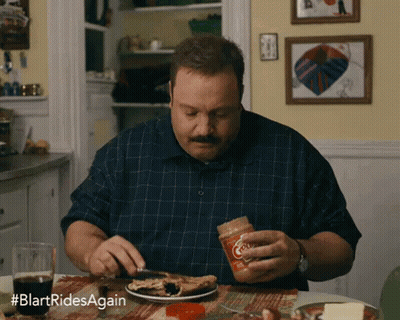 Man Sitting at Table With Plate and Peanut Butter