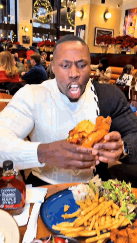 Man Sitting At Table With Plate Of Food And Maple Syrup GIF