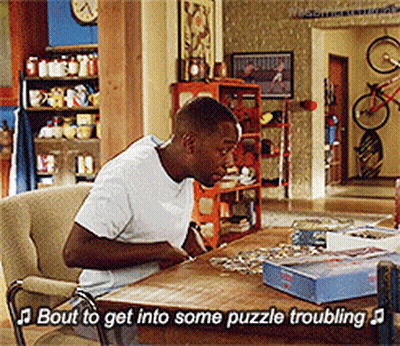 Man Sitting At Table With Puzzles Saying Bout To Get Into Some Puzzle Troubling GIF