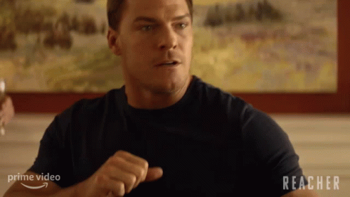 Man Sitting At Table With Reacher GIF