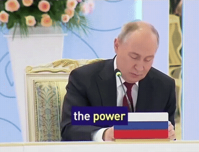 Man Sitting At Table With Sign Saying The Power GIF