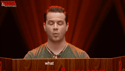 Man Sitting At Table With Sign Saying What Are You Doing GIF